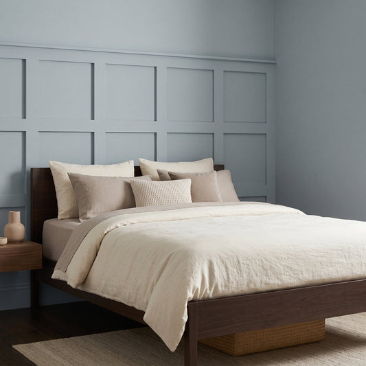 MDF wall panels: light blue grid wall paneling behind a bed