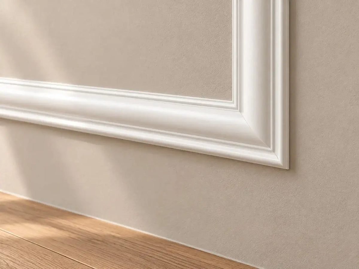 Close-up of a mitered picture frame molding corner on a wall