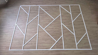 Pre-cut Asymmetric Wall Molding Kit pieces laid out before installation
