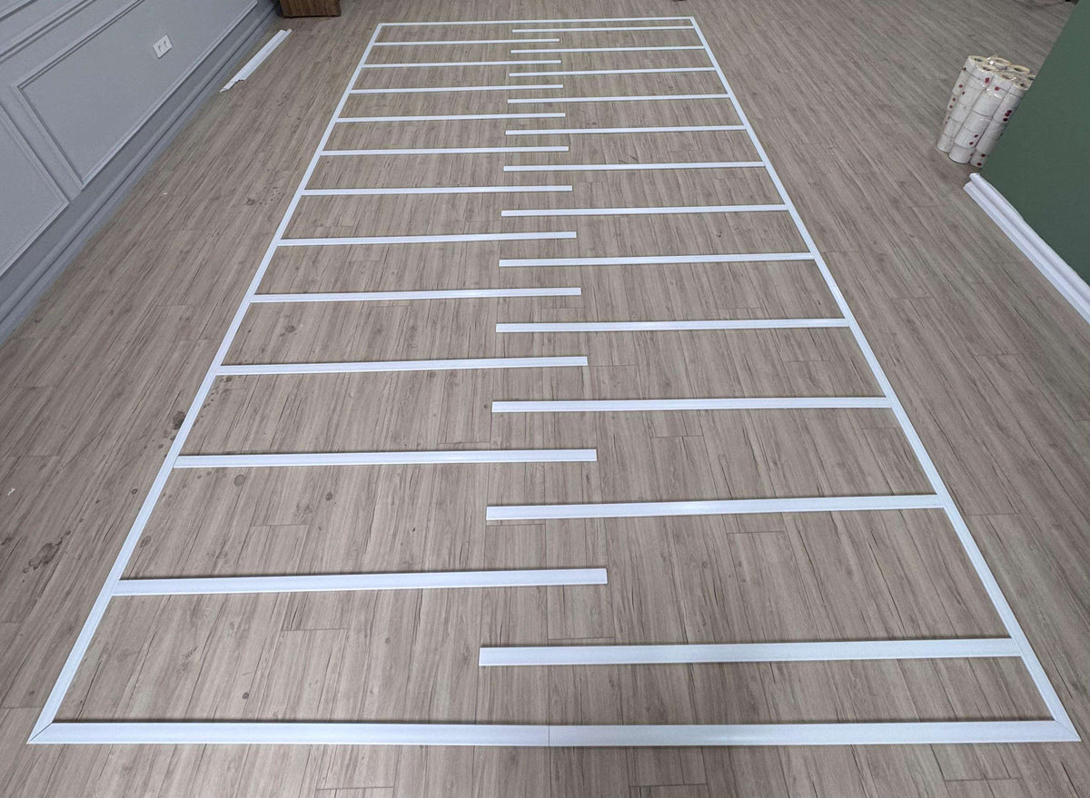 Pre-cut Flat Wall Molding Kit pieces laid out before installation