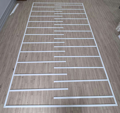 Flat Wall Molding Kit pieces laid out on the floor, second view