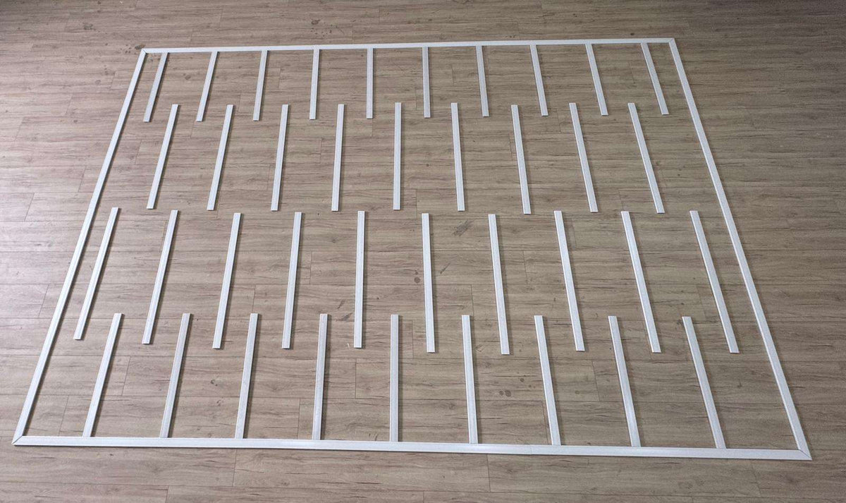 Pre-cut Flat Wall Paneling Kit pieces laid out before installation